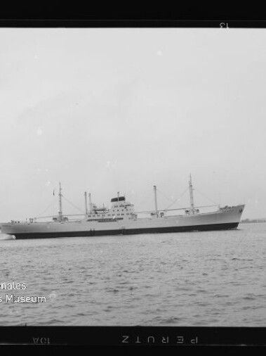 Frachtschiff mit mittigem Aufbau und Ladebäumen auf ruhiger See; Text 'Internationales Maritimes Museum Hamburg'