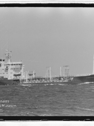 Mittleres Tankschiff mit Aufbau achtern und sichtbaren Rohrleitungen auf hoher See, Wasserzeichen des Museums.