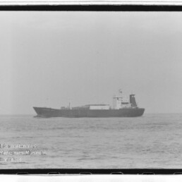 Aufnahme eines Frachtschiffs auf ruhiger See in Schwarzweiß, mit Wasserzeichen Internationales Maritimes Museum Hamburg