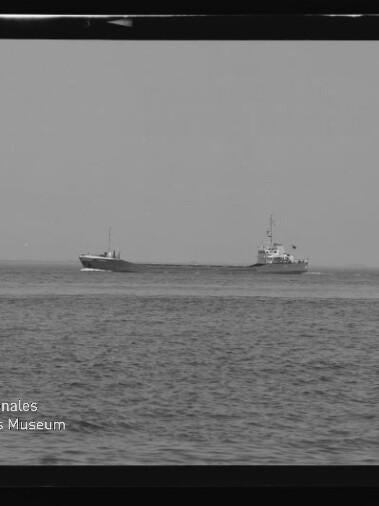 Schwarzweiß-Foto zweier Frachtschiffe auf ruhiger See, leicht versetzt nebeneinander am Horizont, mit sichtbarem Filmrand und dem Wasserzeichen 'Internationales Maritimes Museum Hamburg'.