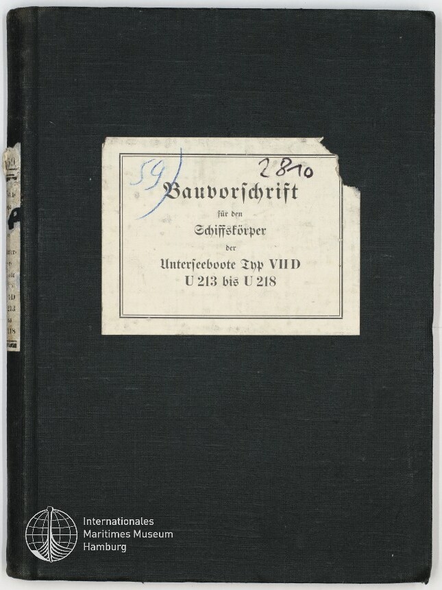 Schwarzer Leineneinband eines Buchs mit rechteckigem, oben rechts leicht eingerissenem weißen Etikett, auf dem in Frakturschrift und Handschrift die Nummern 2810 und 59 sowie der Titel „Bauvorschrift für den Schiffskörper der Unterseeboote Typ VIID U 213 bis U 218“ zu lesen sind; unten links das Logo und der Schriftzug des Internationalen Maritimen Museums Hamburg.