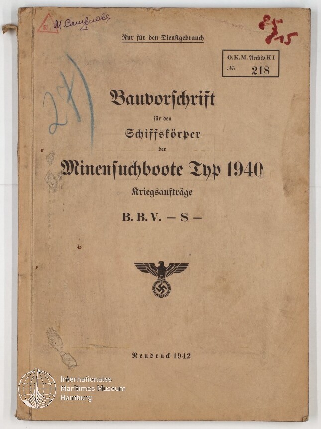 Buchdeckel eines stark gealterten Diensthefts mit dem Titel „Bauvorschrift für den Schiffskörper der Minensuchboote Typ 1940, Kriegsaufträge B.B.V. – S –“, gedrucktem Reichsadler mit Hakenkreuz, handschriftlichen Einträgen, Stempeln und dem Vermerk „Neudruck 1942“