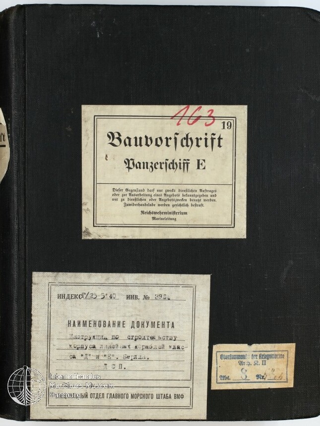 Schwarzer Leineneinband eines Ordners mit mittig aufgeklebtem Schild 'Bauvorschrift Panzerschiff E' (oben handschriftlich rot die Ziffer 163), darunter links ein größeres russischsprachiges Etikett und rechts unten ein kleines Papieretikett.