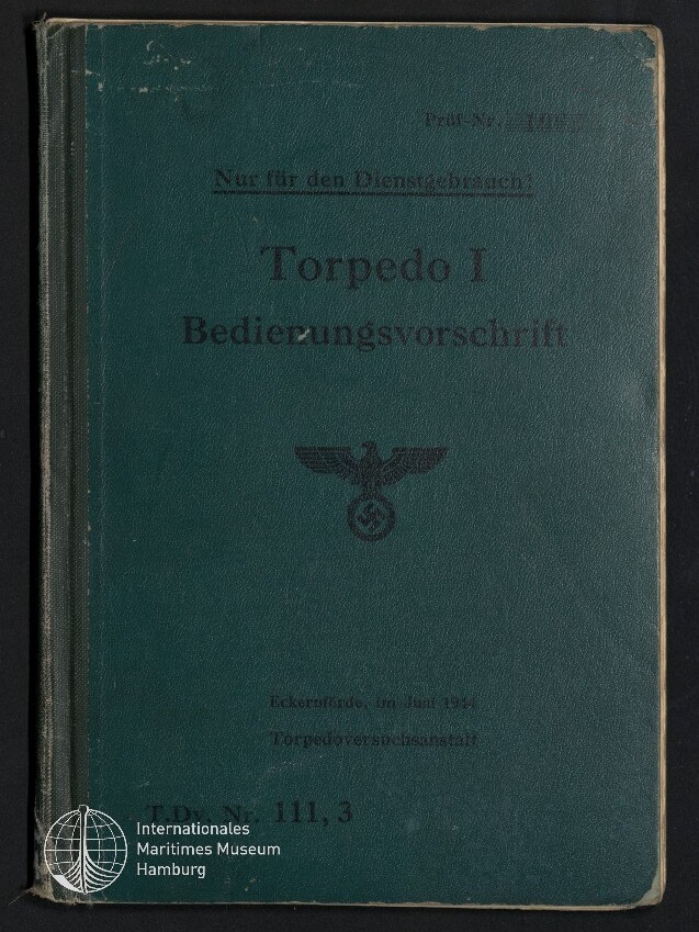 Grünes Hardcover-Handbuch mit dem aufgedruckten Titel ‚Torpedo I Bedienungsvorschrift‘, darunter ein schwarzer Reichsadler über einem Hakenkreuz und ein weißer Stempel des Internationalen Maritimen Museums Hamburg in der unteren linken Ecke.