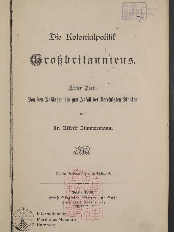 Titelblatt eines vergilbten Buches mit dem großformatigen Schriftzug Die Kolonialpolitik Großbritanniens, Untertitel Erster Theil. Von den Anfängen bis zum Abfall der Vereinigten Staaten, Autor Dr. Alfred Zimmermann und Verlagsangabe Berlin 1898, versehen mit roten Seal-Stempeln, einem violetten Archivstempel oben rechts und einem Museumslogo unten links.