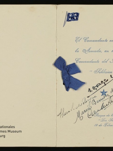 Doppelseitige cremefarbene Grußkarte mit blauem Schleifenornament, gedrucktem spanischen Text und handschriftlichen Unterschriften auf der rechten Seite, Museumslogo links unten.